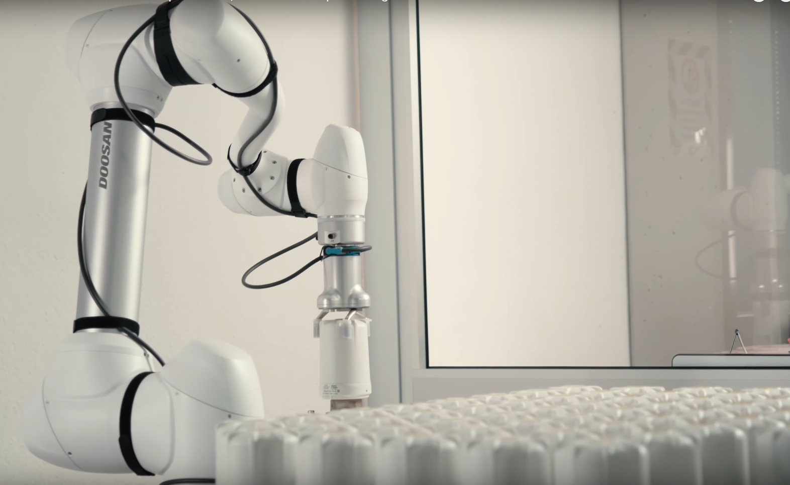 Collaborative robot performing automated testing on SPINCap electronic component