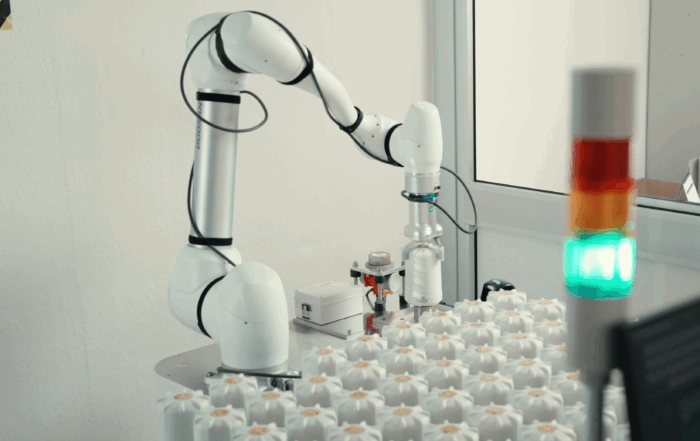 Collaborative robot performing automated testing on SPINCap electronic component