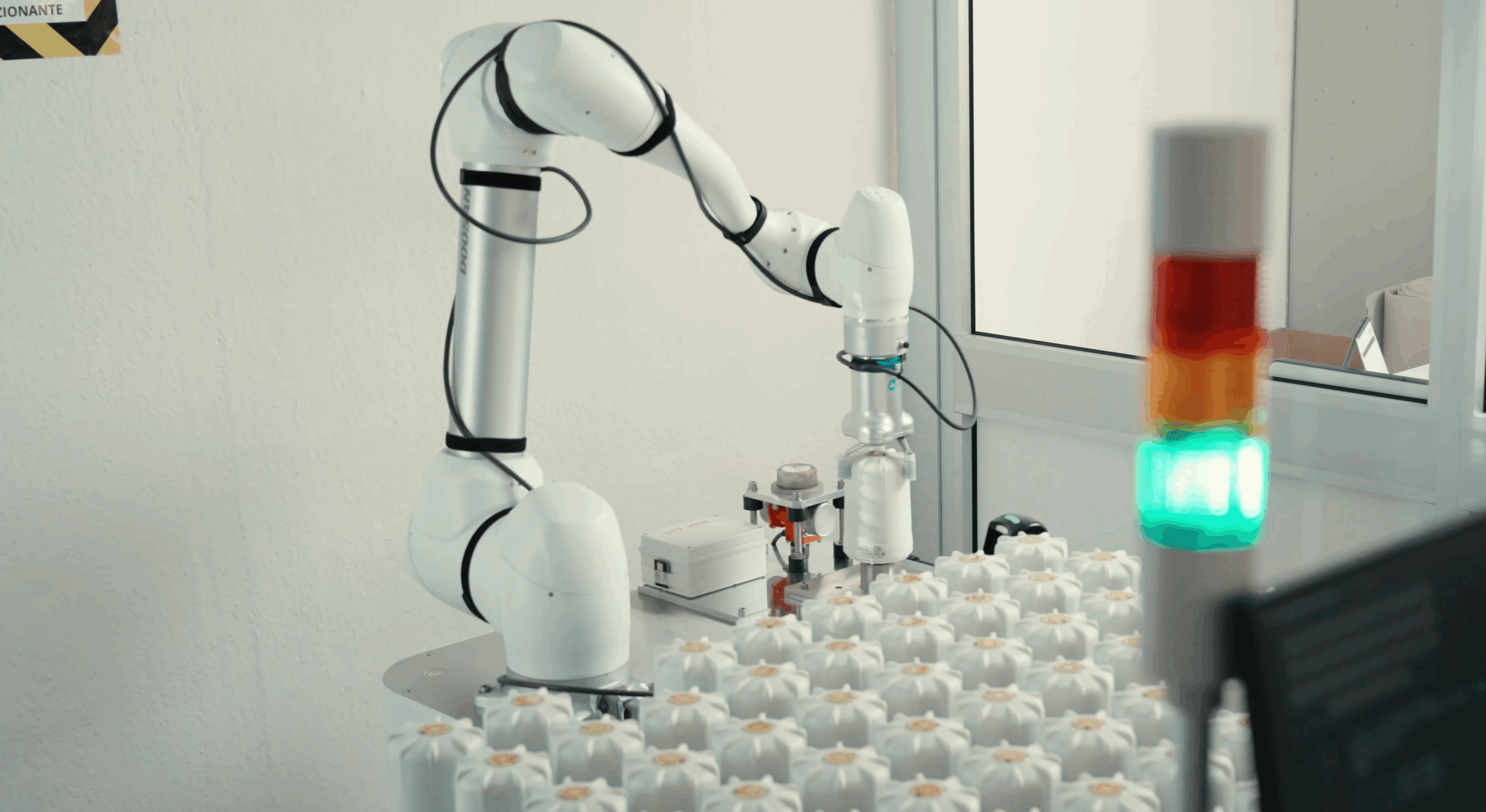 Collaborative robot performing automated testing on SPINCap electronic component
